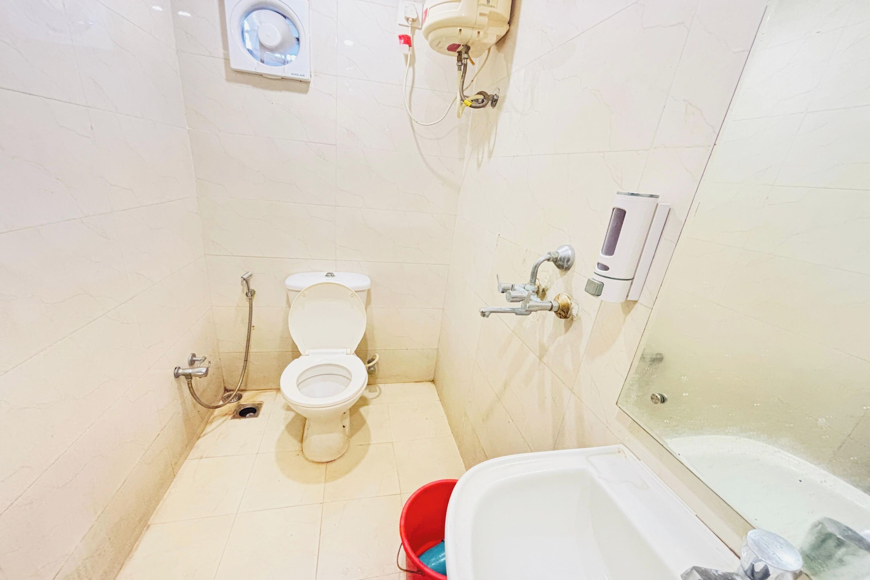A small bathroom with a toilet, a shower, and a bathtub.