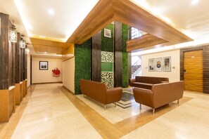 A modern lobby with a wooden ceiling, green wall accents, and a reception desk. - FabHotel Prime The Bentree (Bhopal)