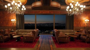 A luxurious room with a large sofa set, two chandeliers, and a view of a cityscape at dusk. - Ayan Zalaat (Ulaanbaatar)
