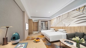 A modern hotel room with a wooden desk, a massage chair, a bed, and a sofa. - Langson Dongguan - Dalang Songshan Lake (Dongguan)