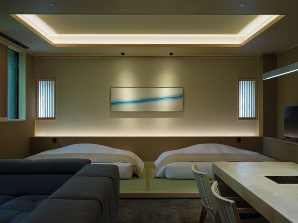 A modern hotel room with a bed, a desk, and a sofa. - suigan (Sapporo)