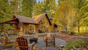 A wooden cabin with a covered patio, outdoor seating, and a fire pit. - Spectacular Private Mountain Cabin on 6 Acres, Epic Outdoor, Hot Tub, Game Room, Pond (Rhododendron)
