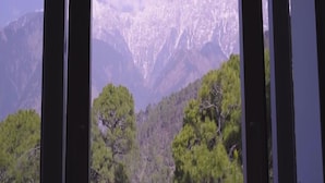 A mountain landscape with snow-capped peaks and dense forest in the foreground. - Hotel Saheb's Castle - Best Mountain View & Jacuzzi Suites, McLeodganj (Dharamshala)