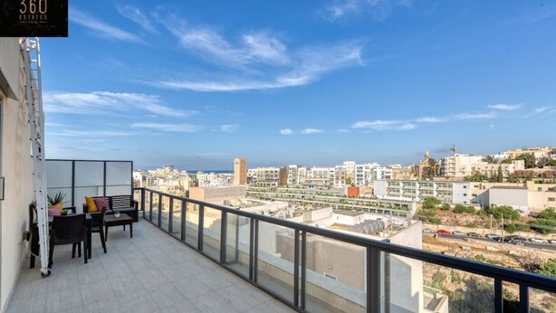 A balcony with a view of a cityscape, a seating area with a table and chairs, and a sign reading "360 ESTATES".