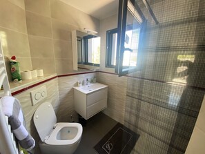 Shower, hair dryer, towels, toilet paper
