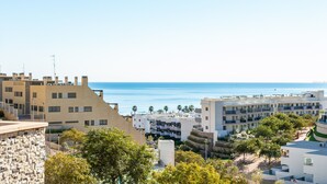A coastal urban area with modern buildings, a clear sky, and a view of the sea. - Apartment 'Luxury Flat Beach Resort Sea View' with Shared Pool, Wi-Fi and Air Conditioning (Arenales del Sol)