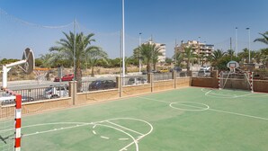 An outdoor basketball court with a net, goal, and hoop. - Apartment 'Luxury Flat Beach Resort Sea View' with Shared Pool, Wi-Fi and Air Conditioning (Arenales del Sol)