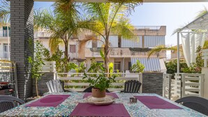 An outdoor dining area with a table set for two, surrounded by chairs, a potted plant, and a white fence. - Holiday Apartment "Samuel Beach Con Veranda" with Private Terrace & Wi-Fi (Cava D'Aliga)