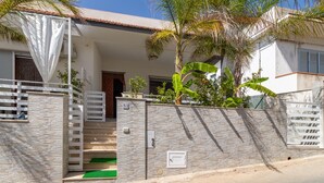 A residential property with a gated entrance, a stone wall, a staircase, and a small garden with plants. - Holiday Apartment "Samuel Beach Con Veranda" with Private Terrace & Wi-Fi (Cava D'Aliga)