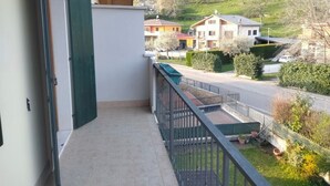 A balcony with a view of a residential street and houses. - Apartment near Verona with Mountain Views (Rovere' Veronese)