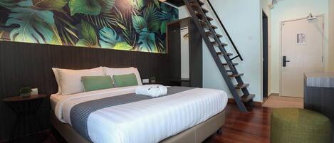 A modern bedroom with a large bed, a staircase, and a tropical leaf mural on the wall.