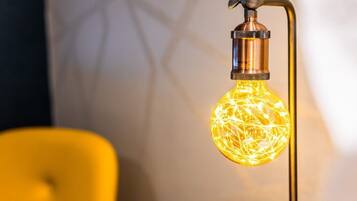 A light fixture with a spherical bulb and a metallic base.