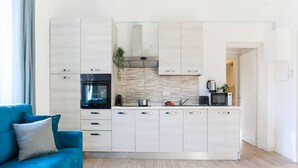 A modern kitchen with white cabinetry, a built-in oven, and a microwave. - The Best Rent - Contemporary two bedroom flat in Porta Romana (Milano)