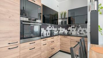 Deluxe Apartment, 1 Bedroom, Ensuite, City View | Private kitchenette | Full-size fridge, microwave, oven, stovetop