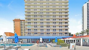 A hotel with a large pool area, multiple balconies, and a restaurant. - Studio with Beach Access and Panoramic City View Miami! (Sunny Isles Beach)
