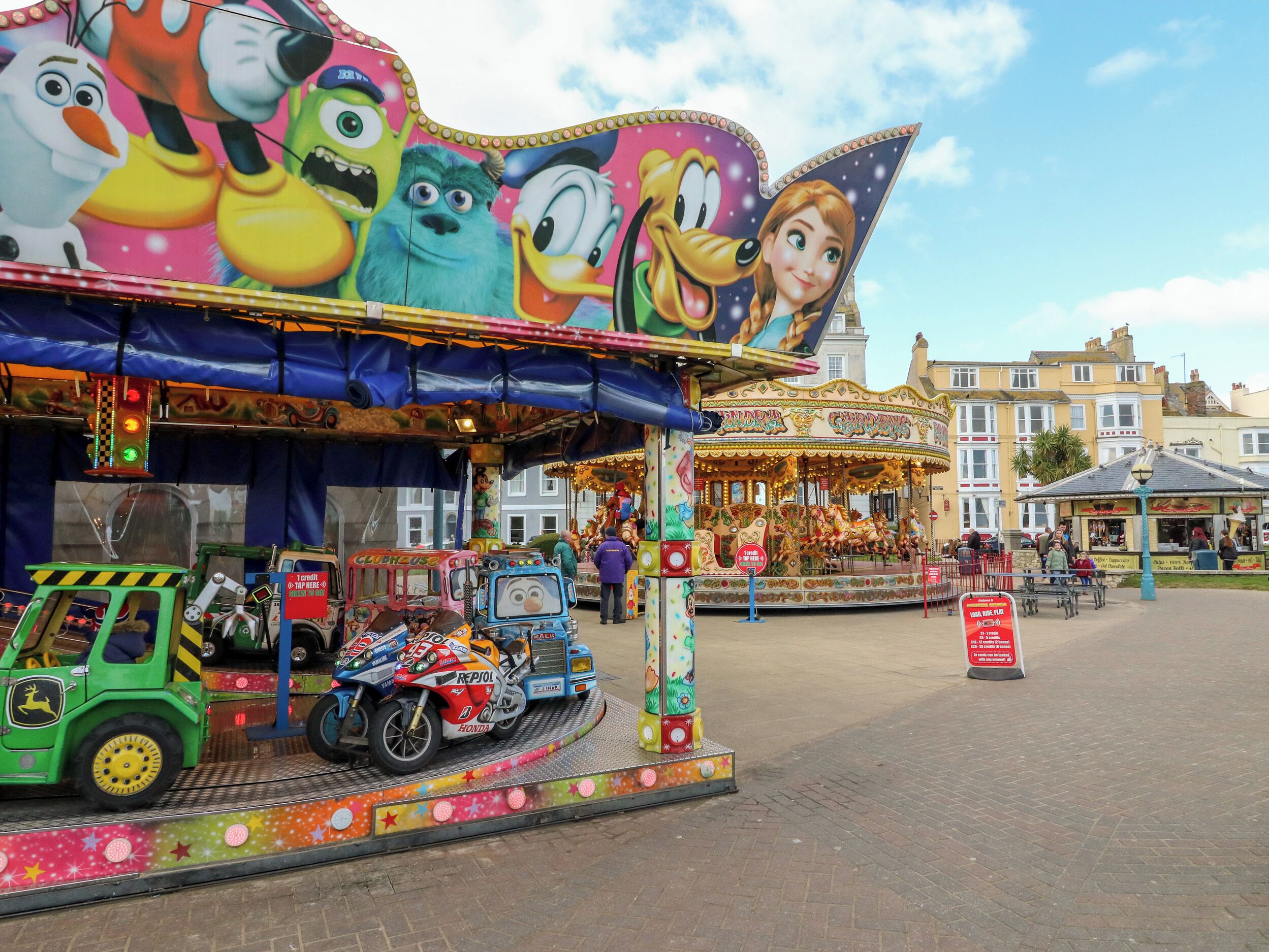 A carousel with colorful decorations and a sign that reads "GARDENIA."
