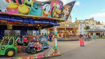 A carousel with colorful decorations and a sign that reads "GARDENIA."