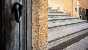 A set of stone steps leading to a door with a metal handle. - 1 Bedroom Apartment in Caltagirone (Caltagirone)