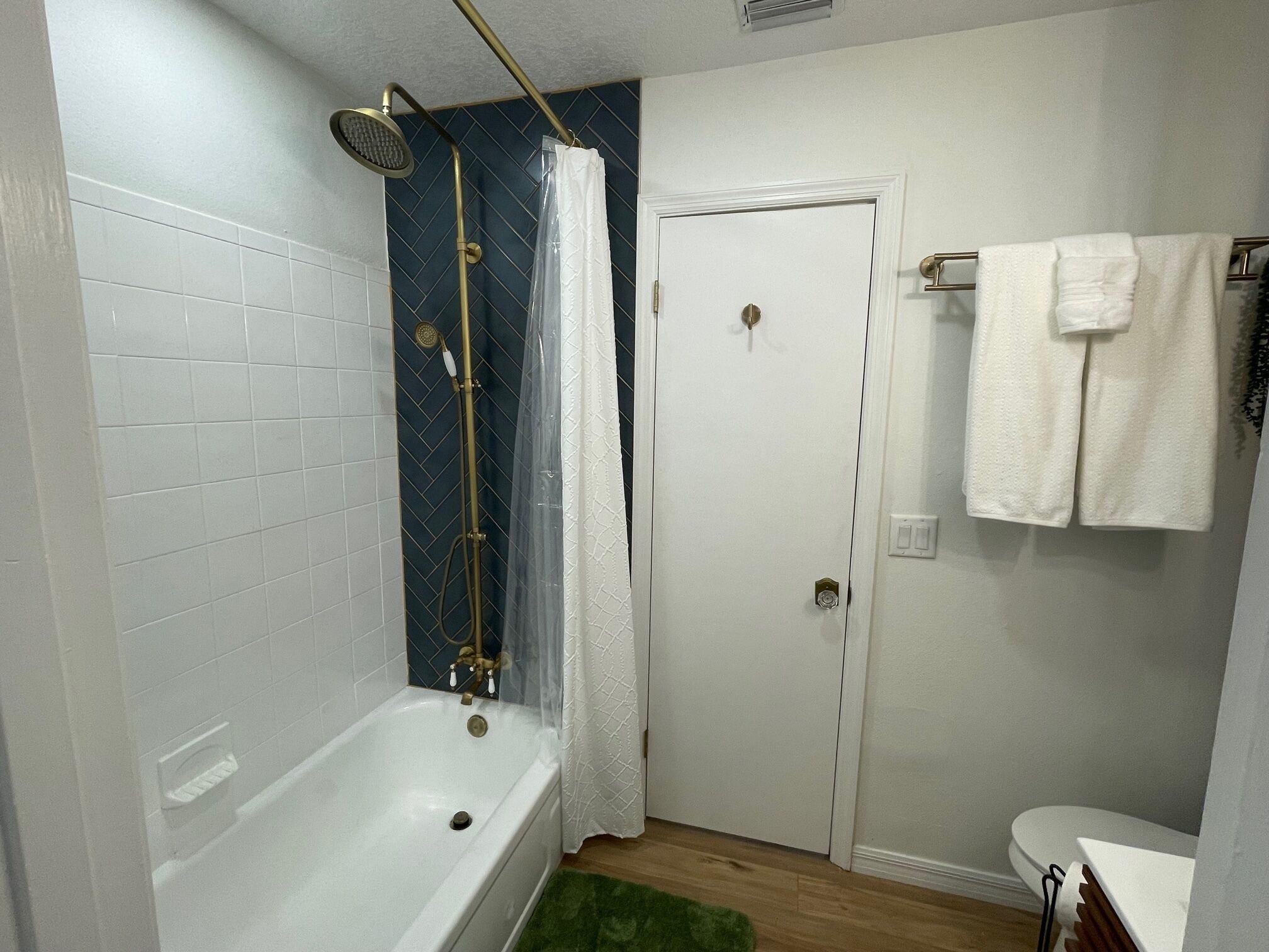 A bathroom with a bathtub, a shower, and a toilet.