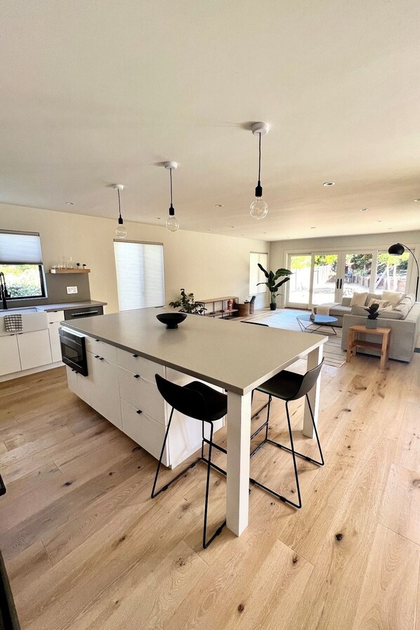 Open chef’s kitchen/family room with entry to the backyard and pool