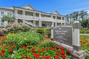 A large, two-story building with a balcony and a sign for Harbour Town Golf Links.