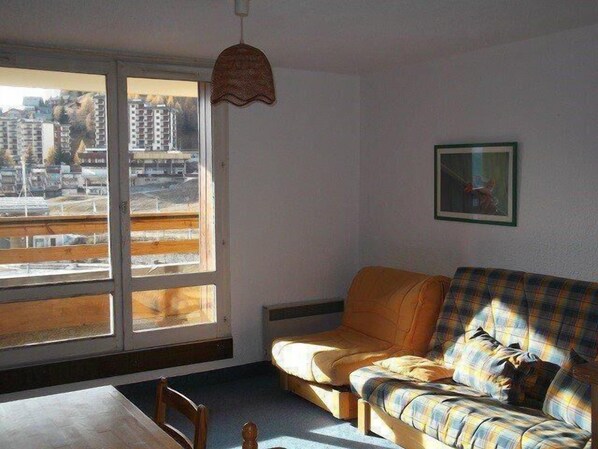 Enjoy city views from the large window, relax on the plaid sofa, and unwind in this stylish room.