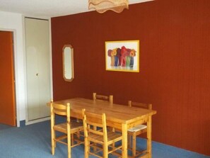 Enjoy meals in the dining area with a wooden table and six chairs.