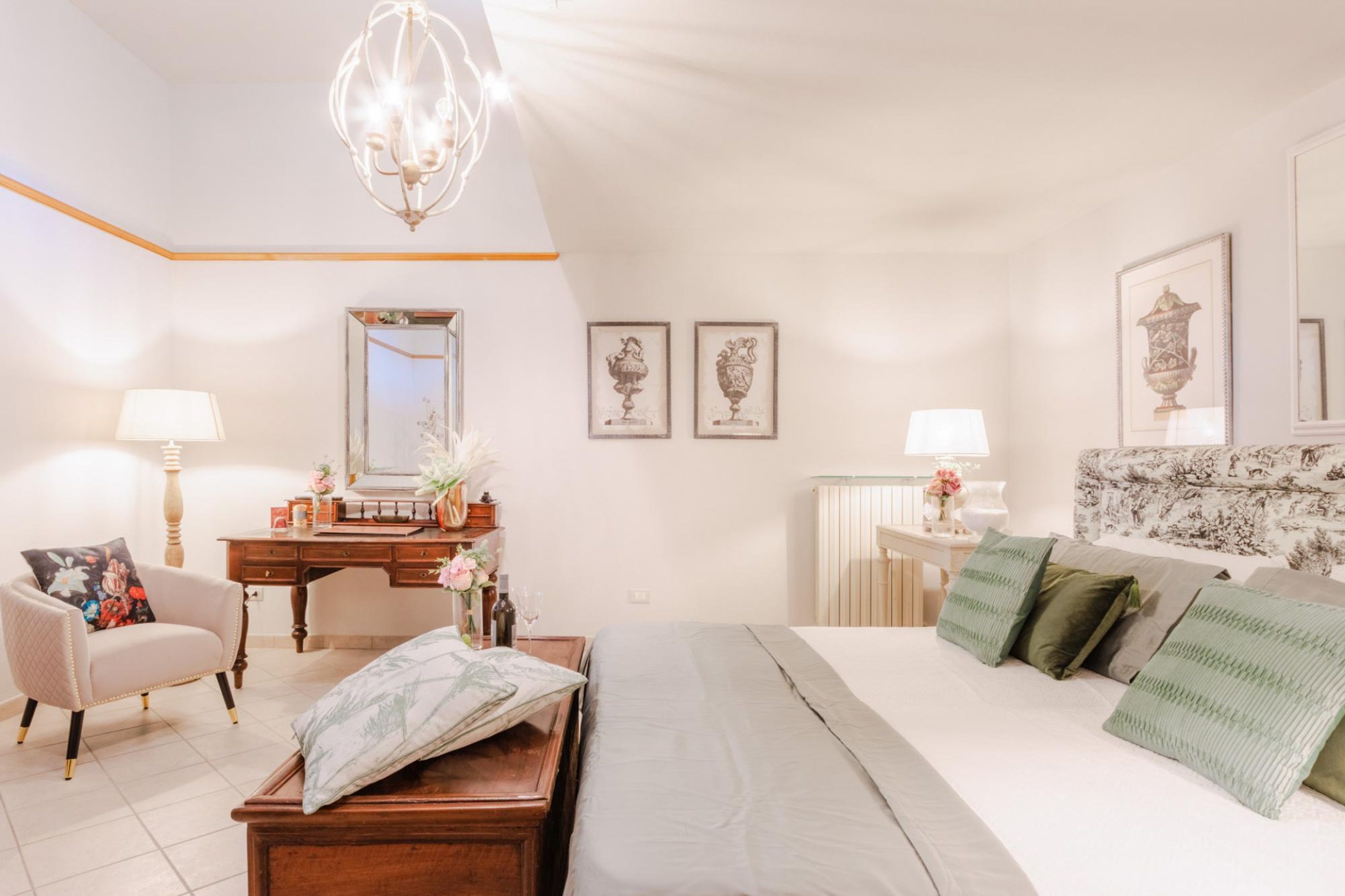 A bedroom with a bed, a desk, a chair, and a mirror.