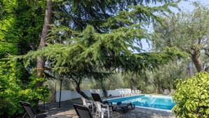 A pool area with lounge chairs and a stone patio. - Apartment Ulivo by Interhome (Chiusanico)