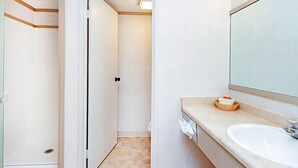 A bathroom with a white sink, a mirror, and a towel rack. - Mountainside Inn 211 1 Bedroom Hotel Room by Alpine Lodging Telluride (Telluride)