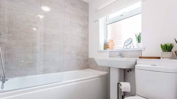 Bathtub, hair dryer, shampoo