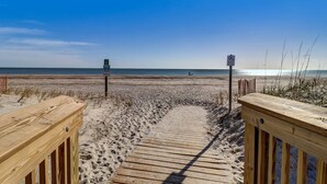 A wooden boardwalk leading to a beach with a clear sky. - 2706 W. 3rd St 2 Bedroom Home by RedAwning (Fernandina Beach)