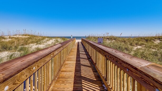 A wooden boardwalk leading to a beach with clear skies. - 2706 W. 3rd St 2 Bedroom Home by RedAwning (Fernandina Beach)