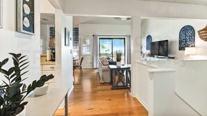 A modern kitchen with a dining area, a large window, and a view of the outdoors. - 8 Sea Castles 3 Bedroom Condo by RedAwning (Fernandina Beach)