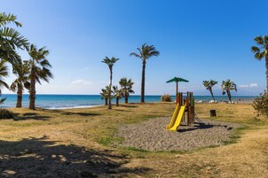 On the beach, white sand, sun-loungers, 3 beach bars