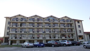 A multi-story hotel with balconies on each floor, a parking lot in front, and a sign reading "hotel Stefania". - Hostel Stefania (Costinesti)