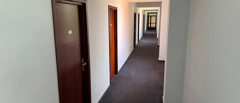 A corridor with doors numbered 221 and 222, leading to rooms.