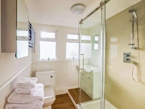 A bathroom with a glass shower enclosure, a toilet, and a sink. - 2 bedroom accommodation in Dartmouth (Dartmouth)