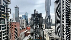A high-rise building with a modern architectural design, surrounded by other tall buildings in an urban setting.