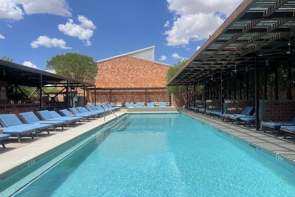 Una piscina al aire libre de temporada, sillones reclinables de piscina