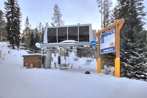 A ski lift station with a sign indicating 'Sunflower Lift' and a small building nearby. - Tyra Penthouse Ski-In/Out — 4BR, Sleeps 12 (Breckenridge)