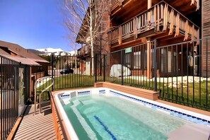 A wooden cabin with a swimming pool, a deck, and a fenced yard. - Tyra Penthouse Ski-In/Out — 4BR, Sleeps 12 (Breckenridge)
