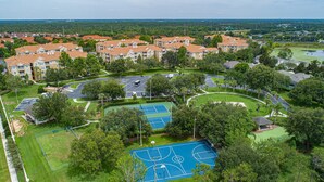 Zona residenziale con palazzi a schiera, un campo da basket e un parcheggio.