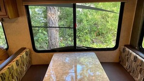A kitchen area with a window view of greenery. - Third Eagle Inn (Lund River)