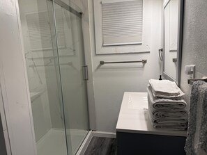 Shower, hair dryer, towels, toilet paper