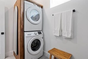 Convenient laundry facilities with a front-loading washer and dryer.