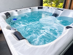 A hot tub with a clear view of the water, a control panel, and a blue floating device. - Seashell Studio - Private Hot Tub, King Bed, Ocean View, Short Walk to the Beach (St. Augustine)