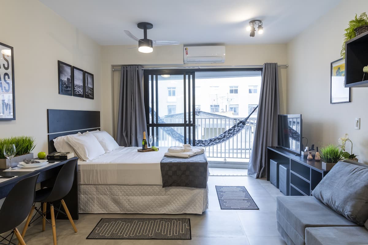 Ein modernes Hotelzimmer mit Bett, Schreibtisch und Sitzecke.