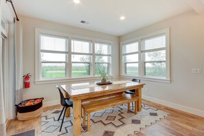 A dining area with a wooden table, black chairs, a bench, and a rug. - Hot Tub & Deck at Red Lodge Retreat (Red Lodge)