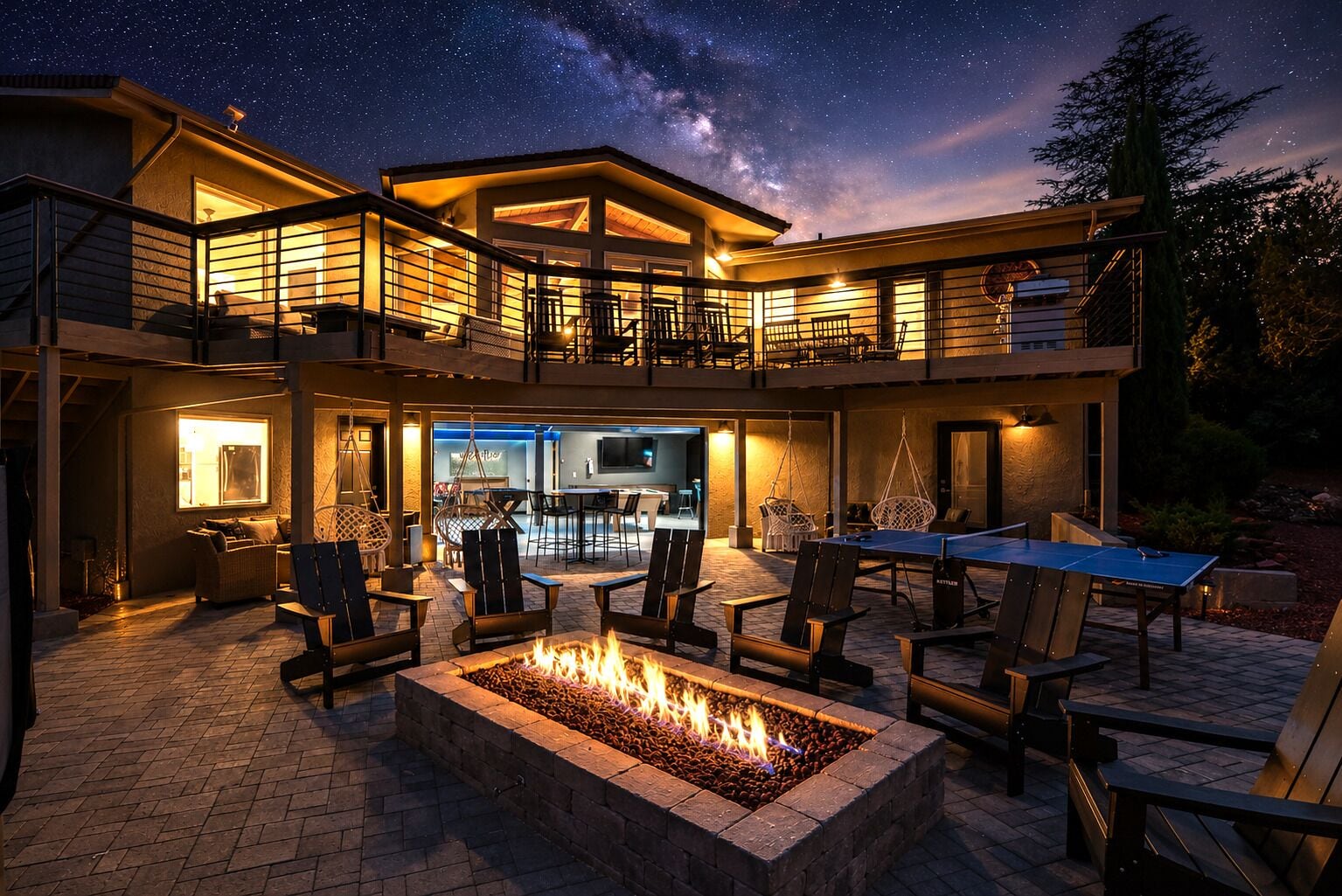 A modern house with a fire pit, outdoor seating, and a pool area.